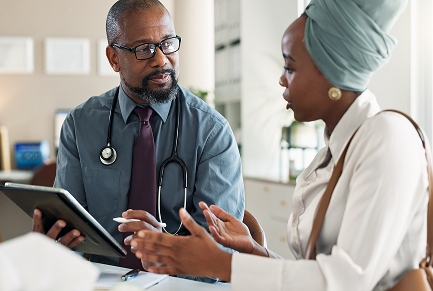 Doctor showing tablet to patient
